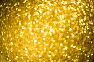 Golden glitter bokeh lighting texture Blurred abstract background for birthday, anniversary, wedding, new year eve or Christmas photo