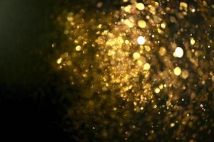 Golden glitter bokeh lighting texture Blurred abstract background for birthday, anniversary, wedding, new year eve or Christmas photo