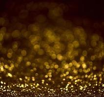 Golden glitter bokeh lighting texture Blurred abstract background for birthday, anniversary, wedding, new year eve or Christmas photo