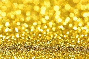 Golden glitter bokeh lighting texture Blurred abstract background for birthday, anniversary, wedding, new year eve or Christmas photo