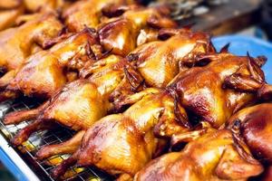 Roasted chicken ready to eat on a steel grill photo