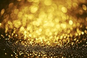 Golden glitter bokeh lighting texture Blurred abstract background for birthday, anniversary, wedding, new year eve or Christmas photo