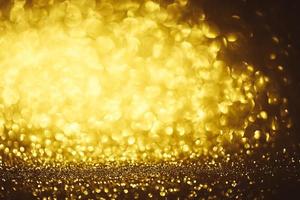 Golden glitter bokeh lighting texture Blurred abstract background for birthday, anniversary, wedding, new year eve or Christmas photo