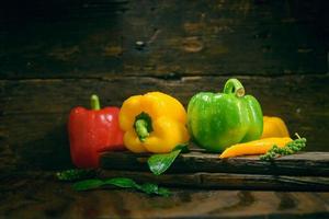 Bell pepper with vegetables on the old wooden floor photo