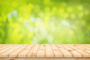 Wood table floor and beautiful natural green leaf abstract blurred bokeh light background photo