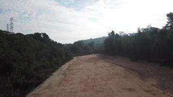 The yellow soil path due to trees clearing video