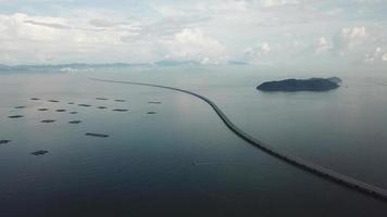 Aerial boat sail at Penang second bridge and fish farm. video