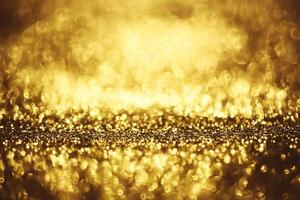 Golden glitter bokeh lighting texture Blurred abstract background for birthday, anniversary, wedding, new year eve or Christmas photo