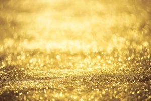 Golden glitter bokeh lighting texture Blurred abstract background for birthday, anniversary, wedding, new year eve or Christmas photo