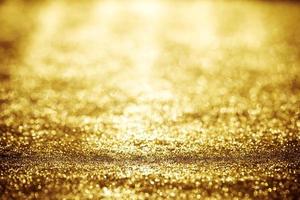 Golden glitter bokeh lighting texture Blurred abstract background for birthday, anniversary, wedding, new year eve or Christmas photo