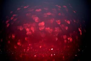 Red Blur heart shape of ligth bokeh on a black background photo