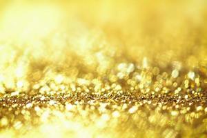 Golden glitter bokeh lighting texture Blurred abstract background for birthday, anniversary, wedding, new year eve or Christmas photo