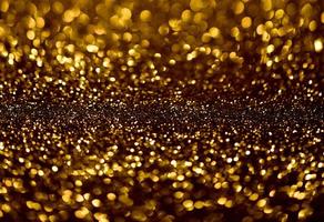 Golden glitter bokeh lighting texture Blurred abstract background for birthday, anniversary, wedding, new year eve or Christmas photo