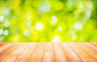 Wood table floor and beautiful natural green leaf abstract blurred bokeh light background photo