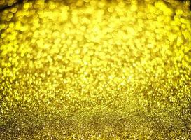 Golden glitter bokeh lighting texture Blurred abstract background for birthday, anniversary, wedding, new year eve or Christmas photo