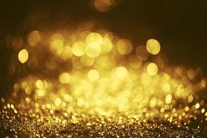 Golden glitter bokeh lighting texture Blurred abstract background for birthday, anniversary, wedding, new year eve or Christmas photo