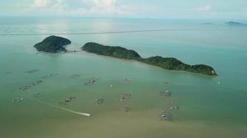 Aerial view boat move at fish farm near Pulau Aman. video