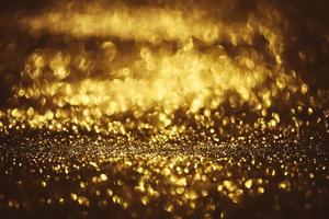 Golden glitter bokeh lighting texture Blurred abstract background for birthday, anniversary, wedding, new year eve or Christmas photo