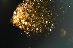 Golden glitter bokeh lighting texture Blurred abstract background for birthday, anniversary, wedding, new year eve or Christmas photo