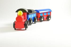 Tren de juguete de madera con bloques de colores aislado sobre fondo blanco. foto