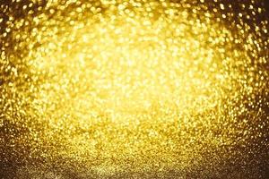 Golden glitter bokeh lighting texture Blurred abstract background for birthday, anniversary, wedding, new year eve or Christmas photo