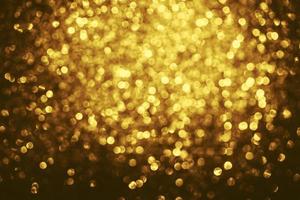 Golden glitter bokeh lighting texture Blurred abstract background for birthday, anniversary, wedding, new year eve or Christmas photo