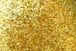 Golden glitter bokeh lighting texture Blurred abstract background for birthday, anniversary, wedding, new year eve or Christmas photo