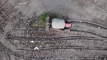 Wet soil in a paddy field being plowed by a tractor at Penang, Malaysia. video