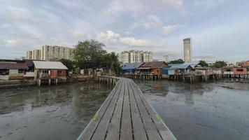 Timelapse cloudy morning at old wooden bridge of clan jetty. video