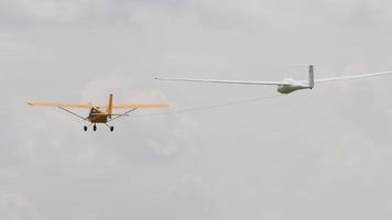 NOVOSIBIRSK, RUSSIAN FEDERATION   JULY 28, 2019 - Glider being towed into the sky by light aircraft. Airshow at the Mochische aerodrome UNNM . video
