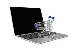 a trolley on a laptop keyboard on white background with clipping path. Concepts about online shopping photo