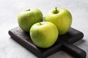 Ripe green apples on a gray concrete background. copy space. photo