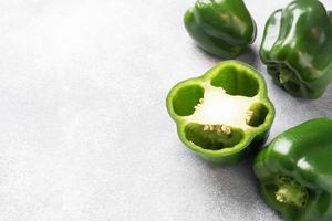 Fresh sweet green pepper on a grey concrete background. Copy space. photo