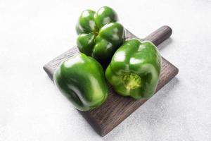Fresh sweet green pepper on a grey concrete background. Copy space.