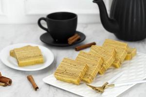 Lapis Legit, Spekkoek, Spekuk,  Indonesian Cake with Thousand Layer. Served on White Plate with Tea photo