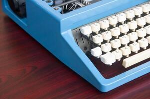 Side view of an old typewriter on wooden table. Copy space photo