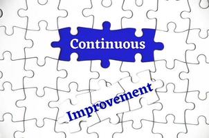 Text on missing jigsaw puzzle - Continuous improvement. photo