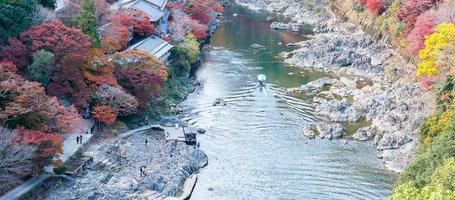 colorful leaves mountains and Katsura river in Arashiyama, landscape landmark and popular for tourists attractions in Kyoto, Japan. Fall Autumn season, Vacation,holiday and Sightseeing concept photo