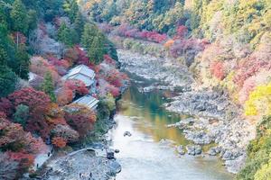 colorful leaves mountains and Katsura river in Arashiyama, landscape landmark and popular for tourists attractions in Kyoto, Japan. Fall Autumn season, Vacation,holiday and Sightseeing concept photo