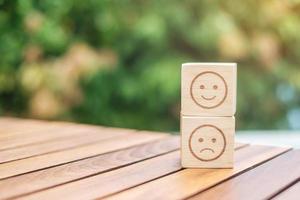 emotion face symbol on wooden blocks. Service rating, ranking, customer review, satisfaction, evaluation and feedback concept photo