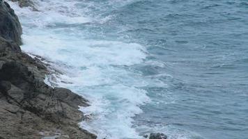 Waves breaking near a rocky shore video