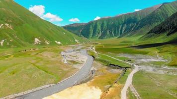 White vehicle slowly drive on gravel terrain with stunning nature landscape. Adventure off-road travel video