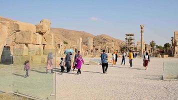 Persepolis, Iran, 2022 - tourist walk by giant column statues - Gates of all nations. Entrance to remains of historical persian city in Persia
