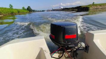 Passenger point of view back of boat with engine and waves. Canal boat ride adventure in Iran video