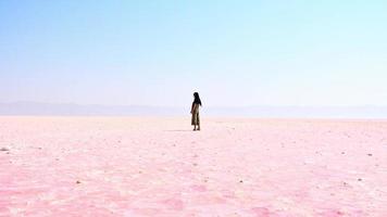 Aerial view young caucasian woman alone walk and explore maharlu salt lake in south Iran, Shiraz video