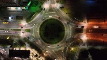 Aerial Top view of car traffic at roundabout lane. Drone aerial zoom out. Urban cityscape concept or abstract of advanced innovation, financial technology, energy power video