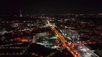 Above view of city streets at night. Areal view from drone at night streets with houses and buildings on background. Concept of night city video