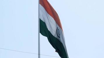 India flag flying high at Connaught Place with pride in blue sky, India flag fluttering, Indian Flag on Independence Day and Republic Day of India, tilt up shot, waving Indian flag, Flying India flags video