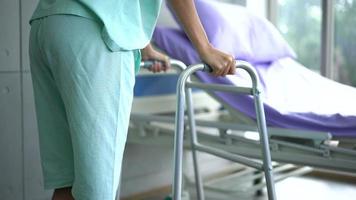 Patient use a walker after accident and cures at the hospital. video