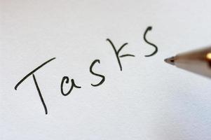 Close up image of handwritten word TASKS. photo